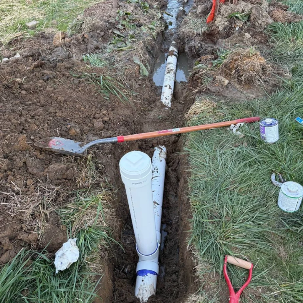 Clog Heroes - Plumber in Stafford VA repairing underground sewer line with new PVC pipe.