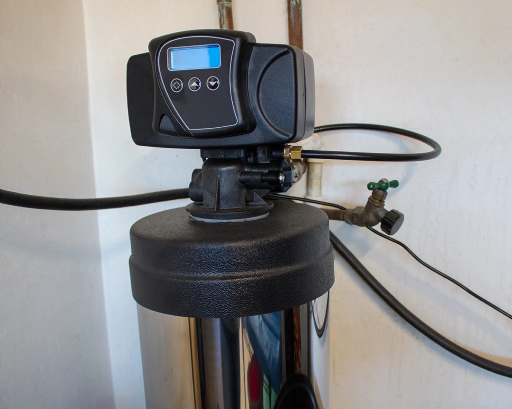 Close-up of a home water softener control valve installed by a plumbing technician. Clog Heroes in Fredericksburg, VA