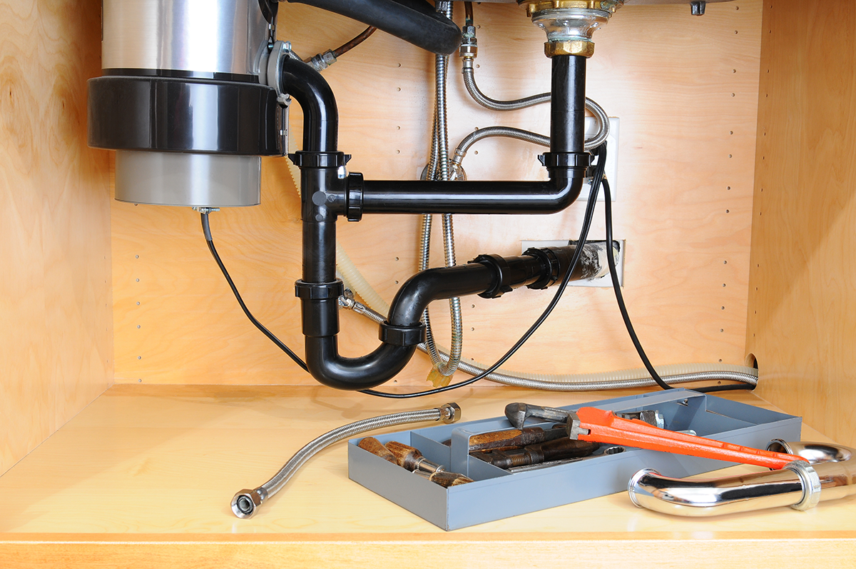 Under-sink plumbing showing a P-trap, illustrating the difference between an S trap vs P trap.