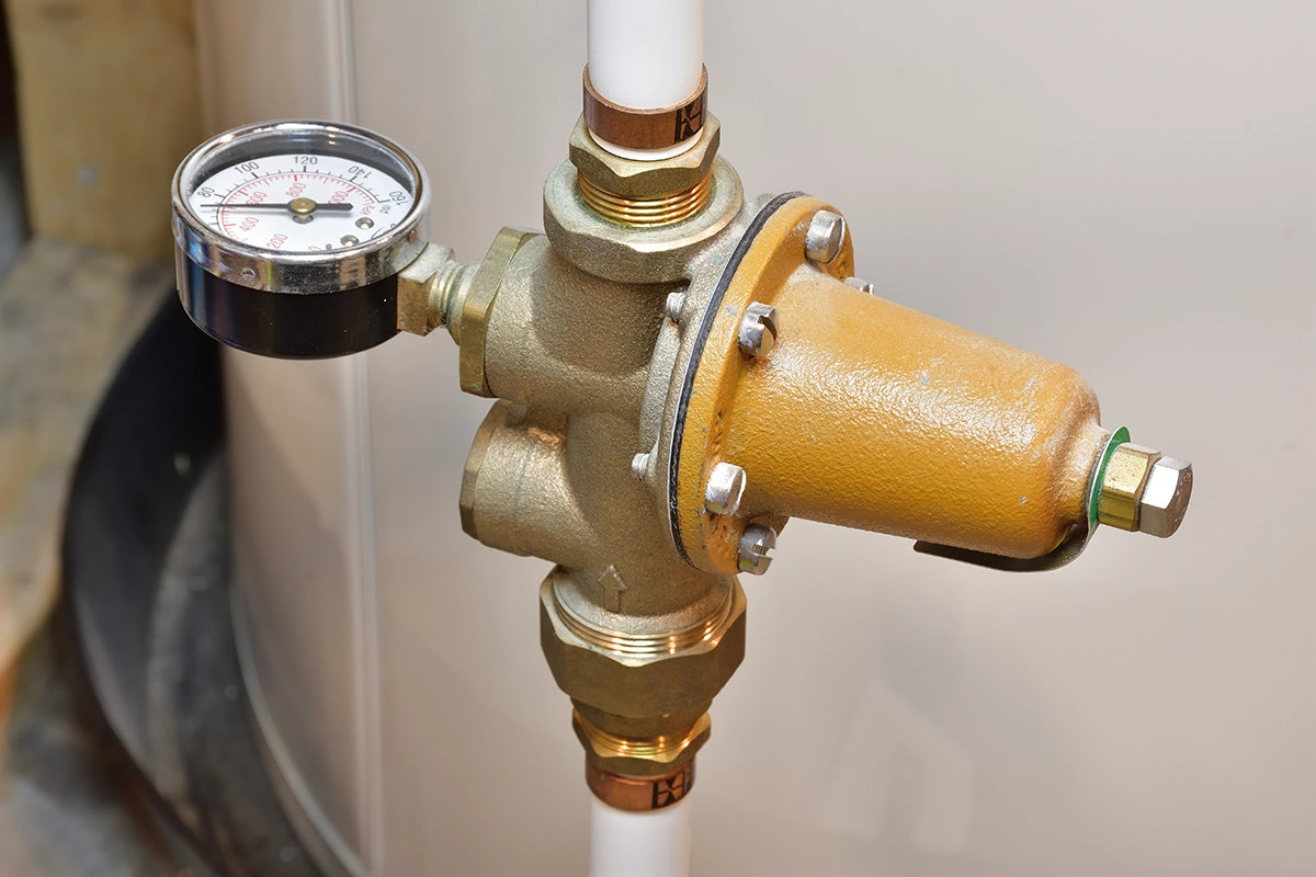 Clog Heroes - PRV Problems: Common Signs and Fixes Installed pressure reducing valve (PRV) with attached pressure gauge on a home plumbing system