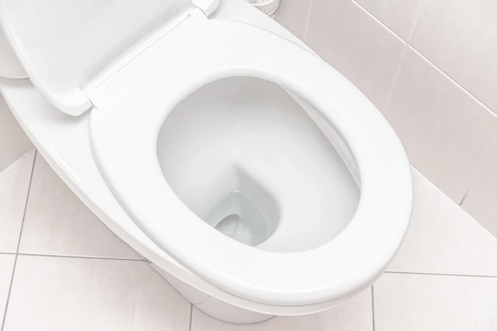 Slow flushing toilet with standing water in the bowl, a common sign of drainage or venting issues