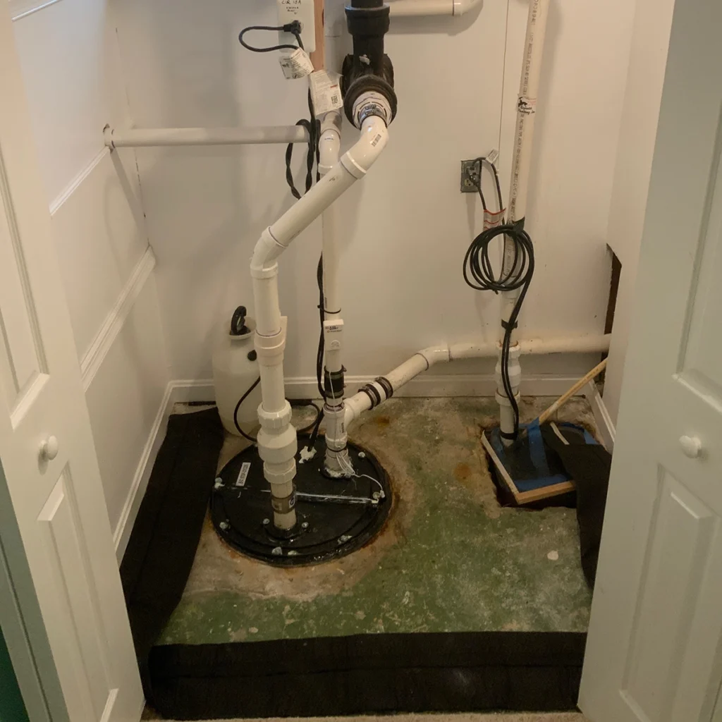 sump pump maintenance setup with sealed sump pit and discharge piping