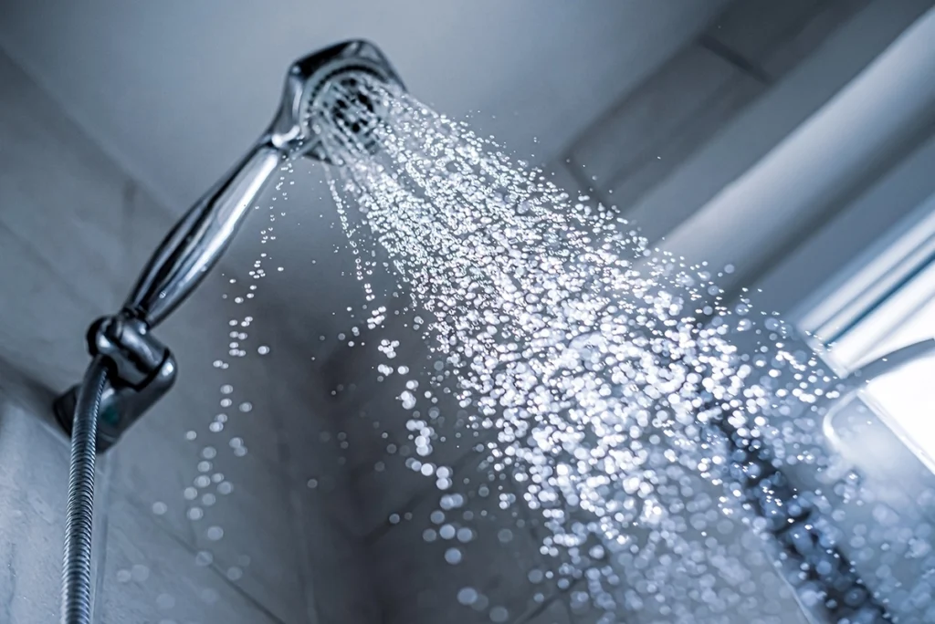 Showerhead running with no hot water in shower conditions, illustrating a common plumbing issue that may require professional diagnosis