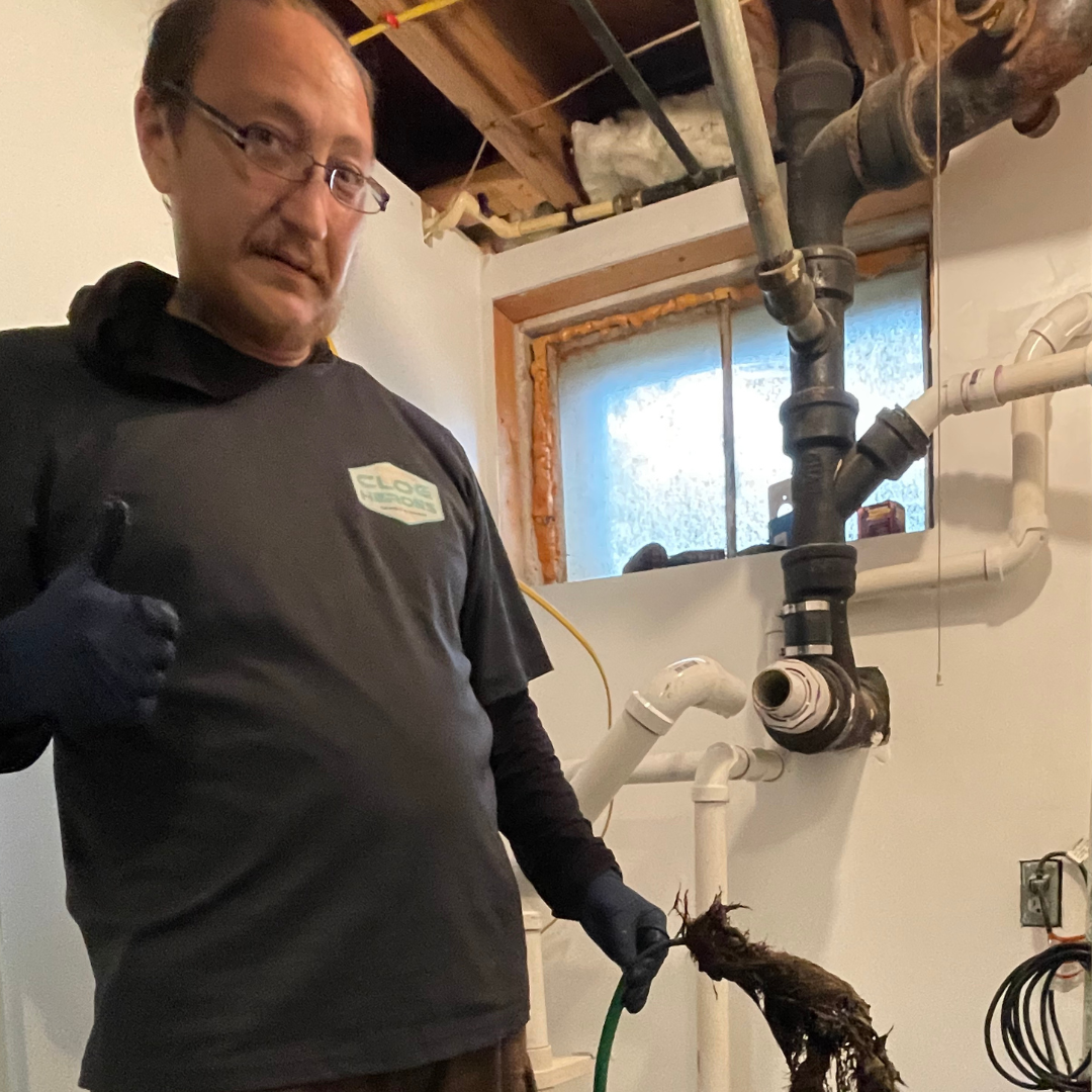 image of clog heroes plumber fixing plumbing issue in Fredericksburg VA